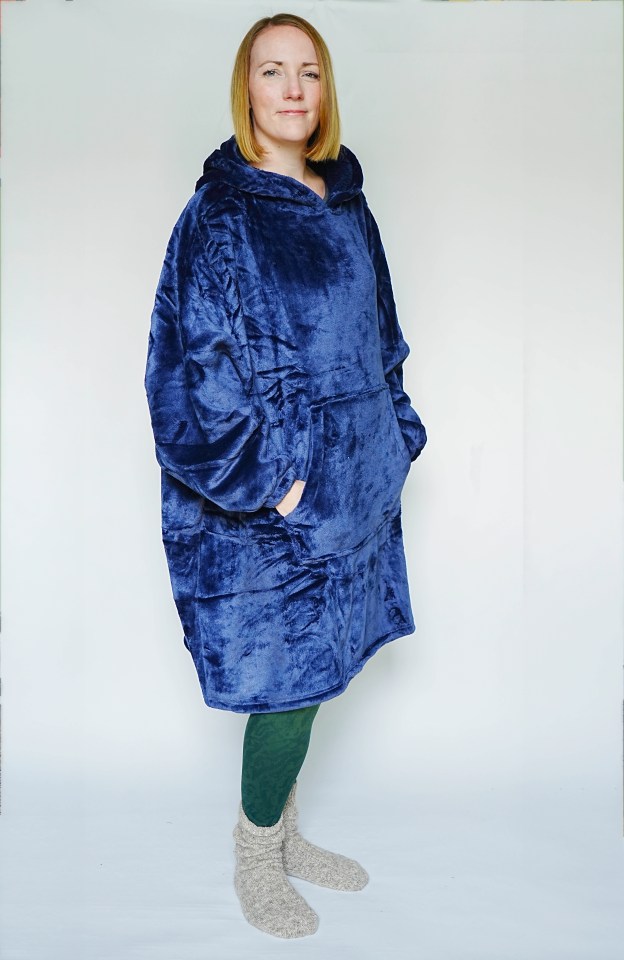 a woman wearing a blue blanket with a hood