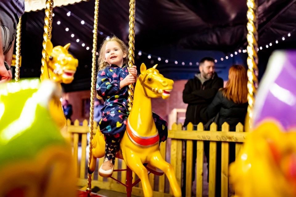 Children can move along the snow trail on a snow sledge, all while underneath sparkling light displays