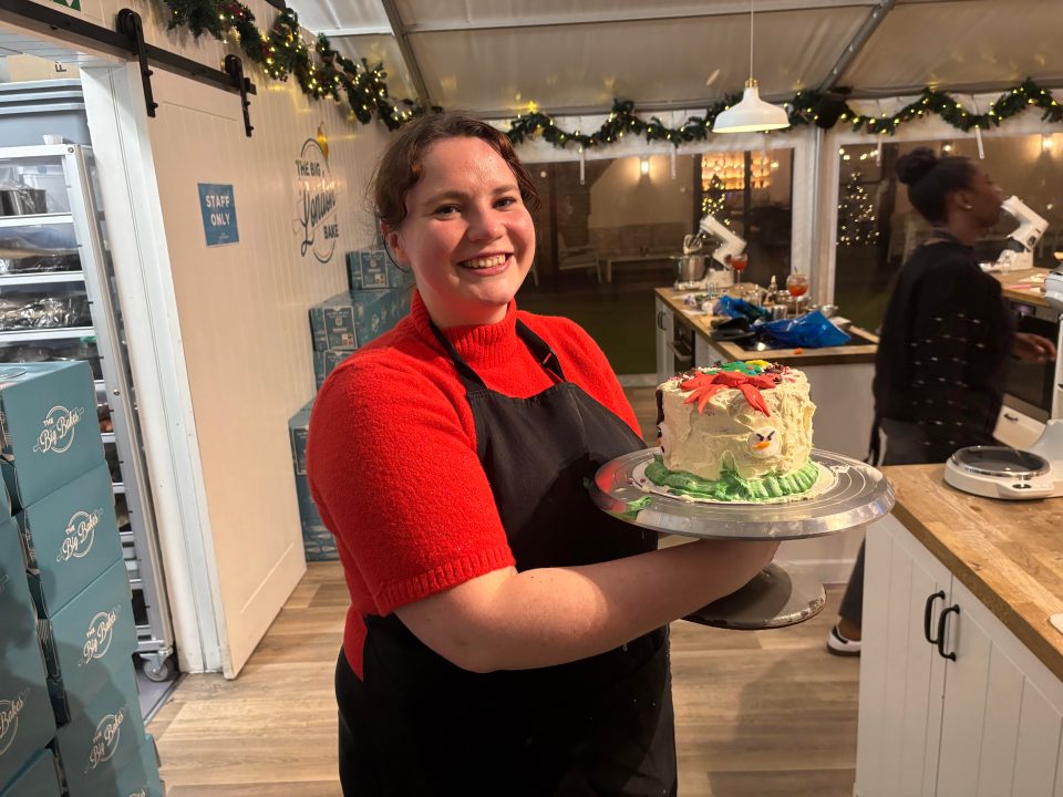 Hope shows off her finished cake before the head baker's inspection