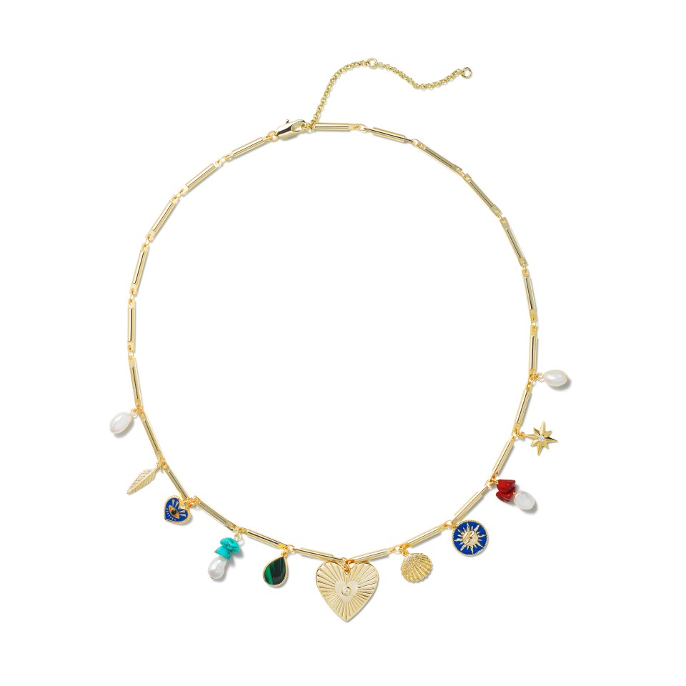 a gold necklace with a heart shaped pendant and other charms