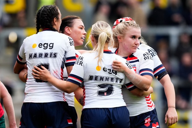 a group of female athletes hugging each other with one wearing the number 9