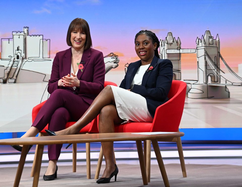 two women sit next to each other in front of a drawing of a bridge