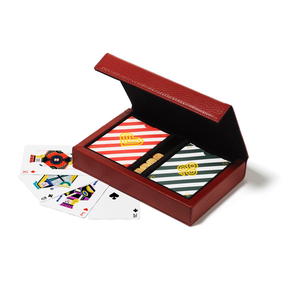 a set of playing cards in a red leather case