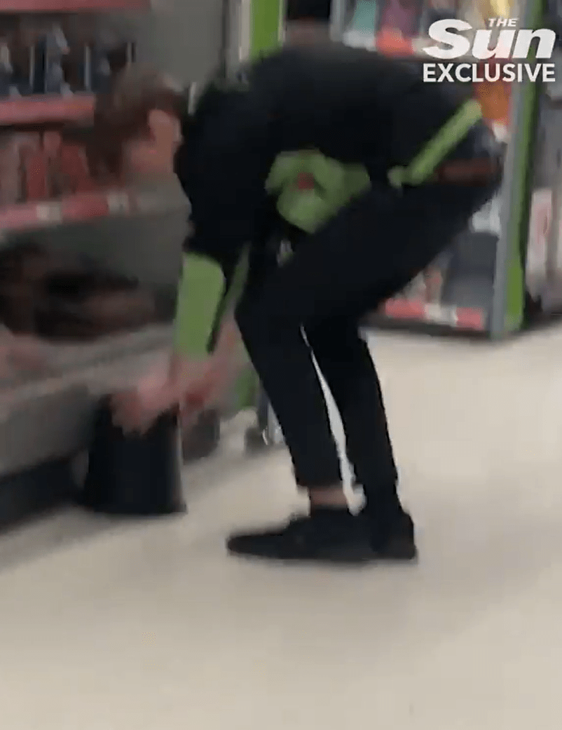 A staff member appears to catch the rodent under a bucket