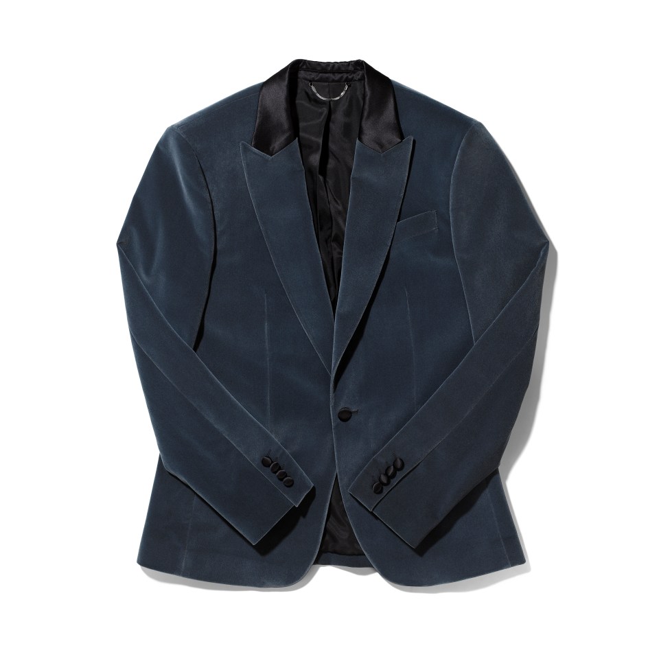 a blue velvet jacket with black buttons on the sleeves