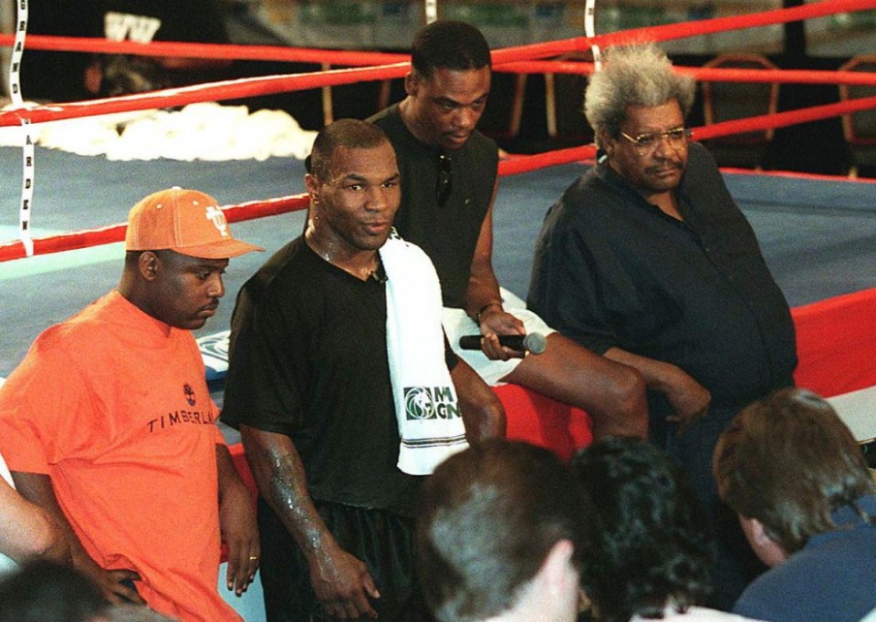 Tyson stands with Holloway, left, John Horn, right, and promoter Don King