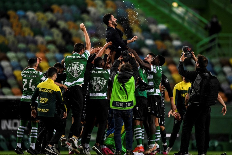 (FILES) Players toss Sporting's head coach Ruben Amorim after winning the Portuguese League football match between Sporting Portugal and Boavista and the Portuguese League title at the Jose Alvalade stadium in Lisbon on May 11, 2021. Ruben Amorim was on November 1, 2024, named as the new manager of Manchester United, replacing the sacked Erik ten Hag. The 39-year-old Portuguese coach, who won two Primeira Liga titles with Sporting Lisbon, has signed a deal until 2027 and will join the club on November 11. (Photo by PATRICIA DE MELO MOREIRA / AFP) (Photo by PATRICIA DE MELO MOREIRA/AFP via Getty Images)