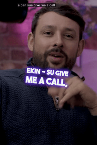 a man with a sign that says ekin su give me a call