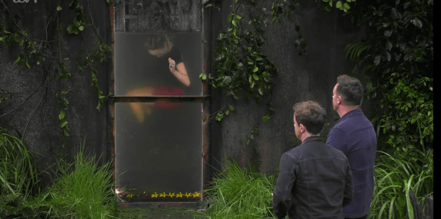 two men are standing in front of a window that says bbc on it