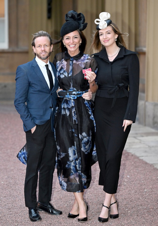 Davina receiving her MBE with Michael and Holly