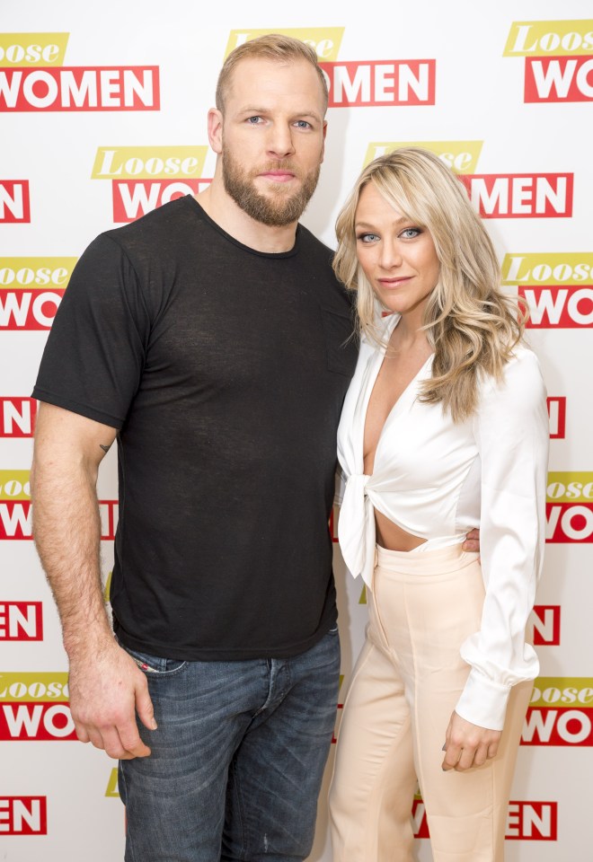 a man and a woman standing in front of a wall that says loose women