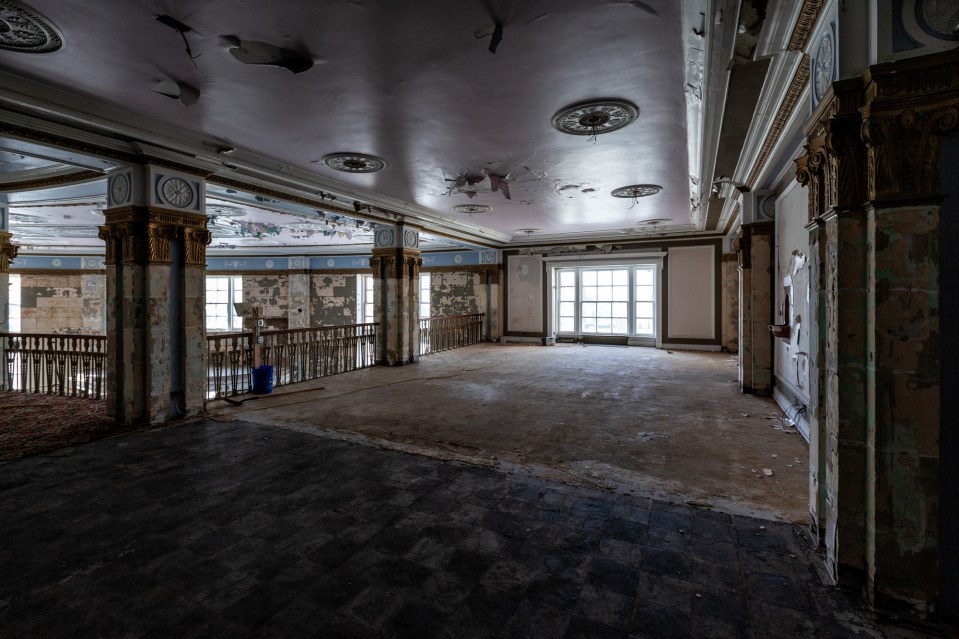 a large room with a ceiling that has a circular design on it