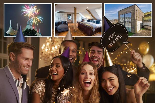 a group of people holding sparklers and a sign that says happy new year