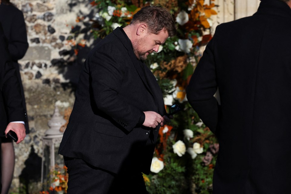 Actor and comedian James Corden bows his head