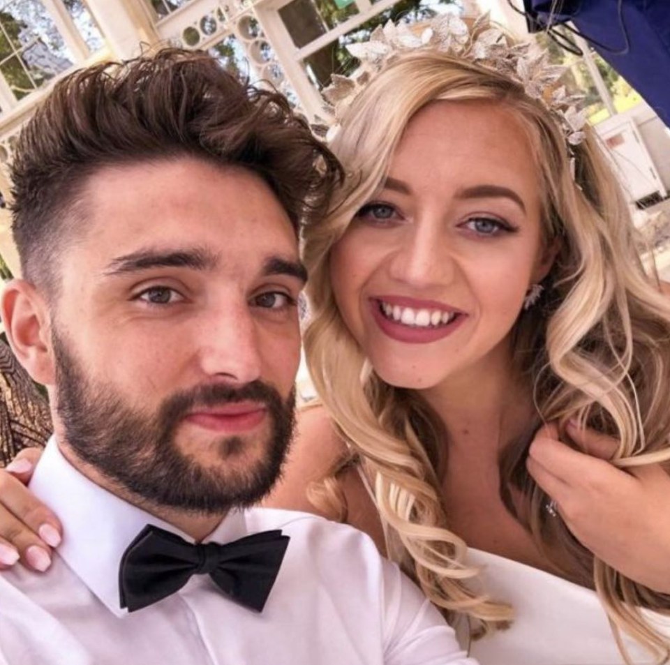 a bride and groom pose for a picture with the bride wearing a tiara