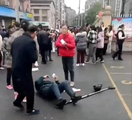 A person lies on the ground following the crash