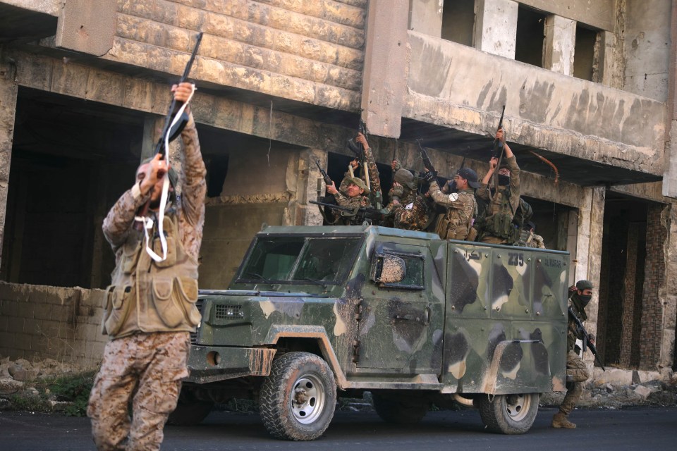 Syrian Islamist rebels celebrate in a street in Maaret al-Numan in Syria’s northwestern Idlib province