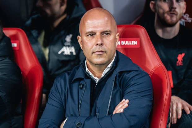 a man sits in a red seat with a bullen sticker on it