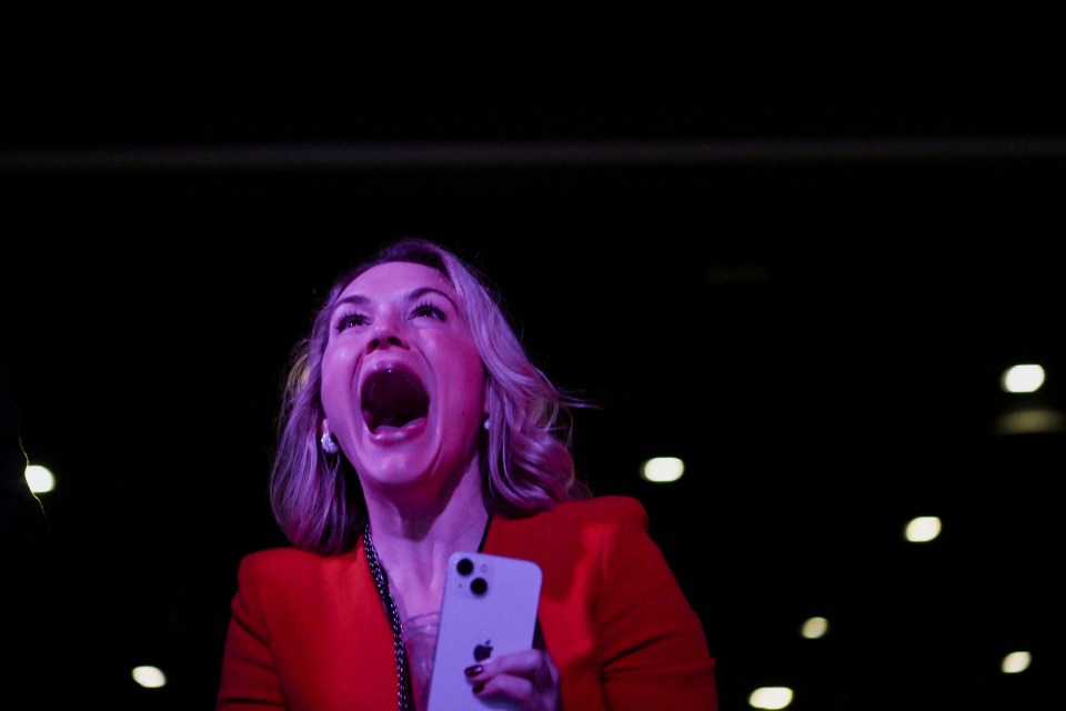 A woman reacts to early election results at Trump's election night watch party in Palm Beach County Convention Center