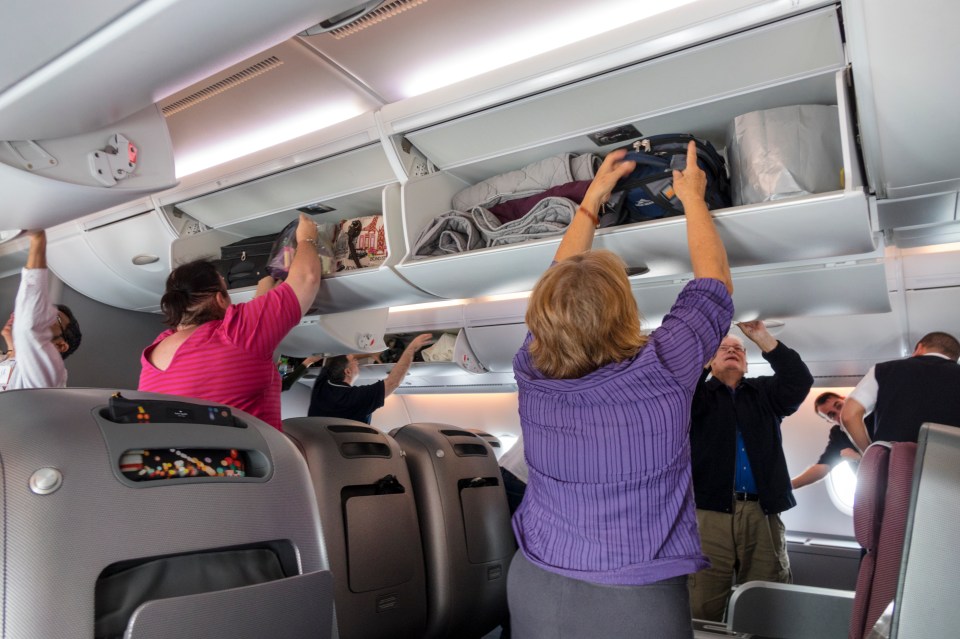 Passengers stowing their luggage for take-off