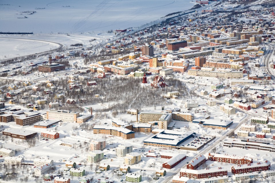 an aerial view of a city covered in snow