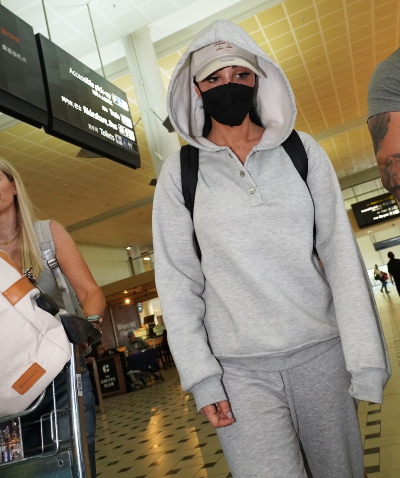 Former X Factor judge Tulisa in stealth mode as she touches down in OZ