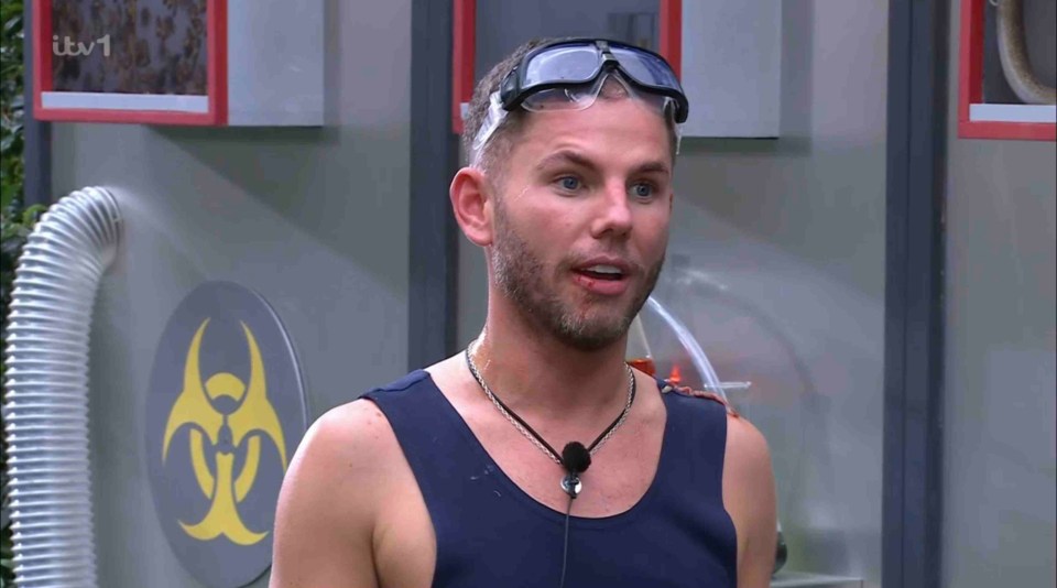 a man wearing sunglasses stands in front of a sign that says itv 1