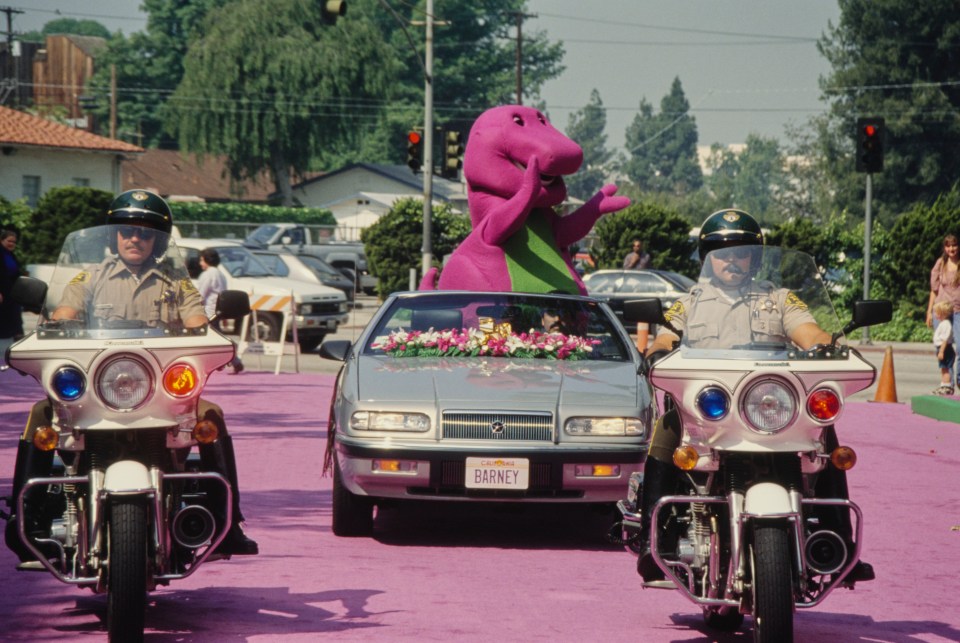 Barney was loathed by adults and is seen riding in a convertible car