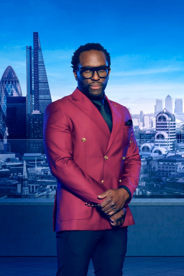 a man in a red suit stands in front of a city skyline