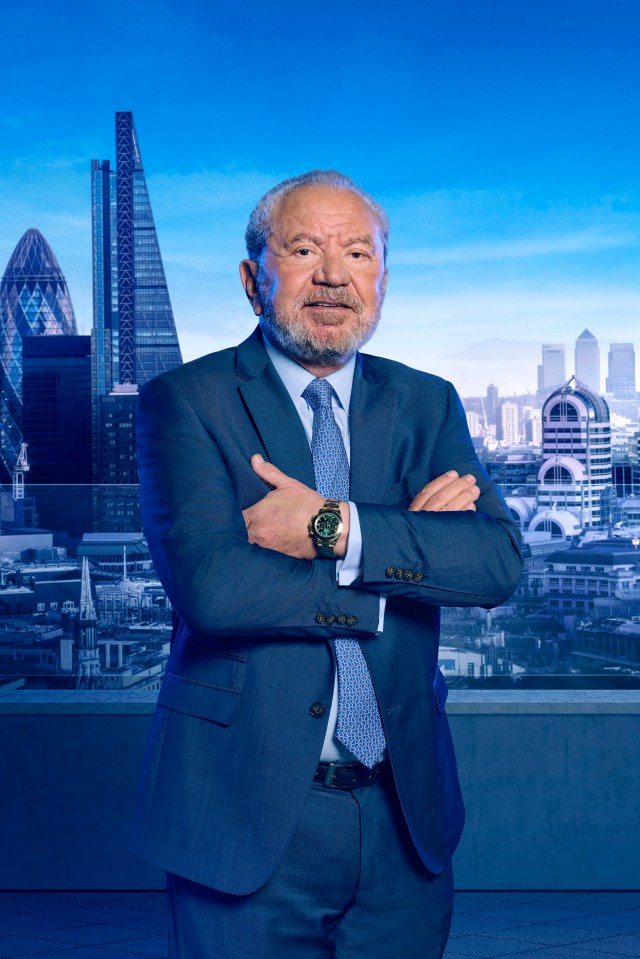 a man in a suit and tie stands with his arms crossed in front of a city skyline