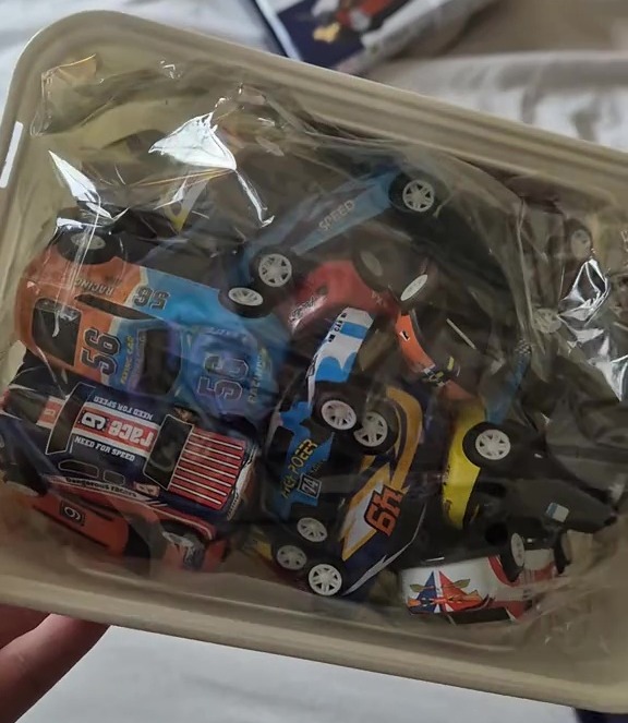 Sadie purchased this box of cars from TikTok, and said they'd work with her son's Hot Wheels tracks