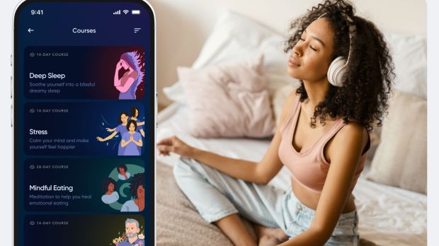 a woman wearing headphones sits on a bed with her eyes closed next to a phone that says courses