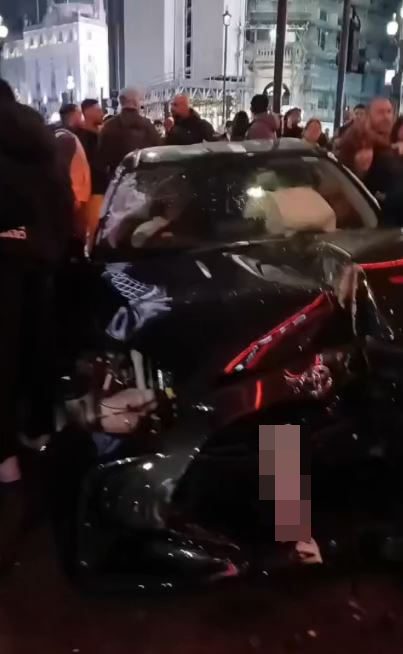 The mangled car stuck on a pavement in Piccadilly Circus