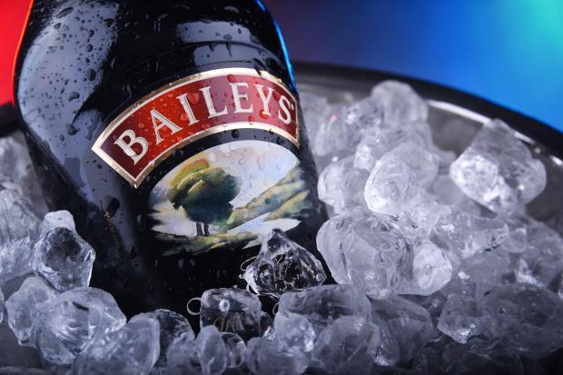 a bottle of baileys sits in a bucket of ice