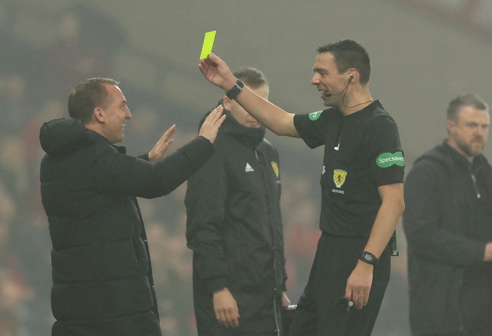 a referee is giving a yellow card to another referee