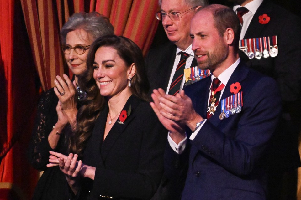 a group of people with medals on their jackets are clapping