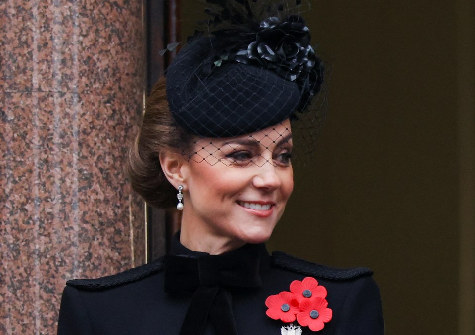 a woman wearing a black hat and a red flower pin