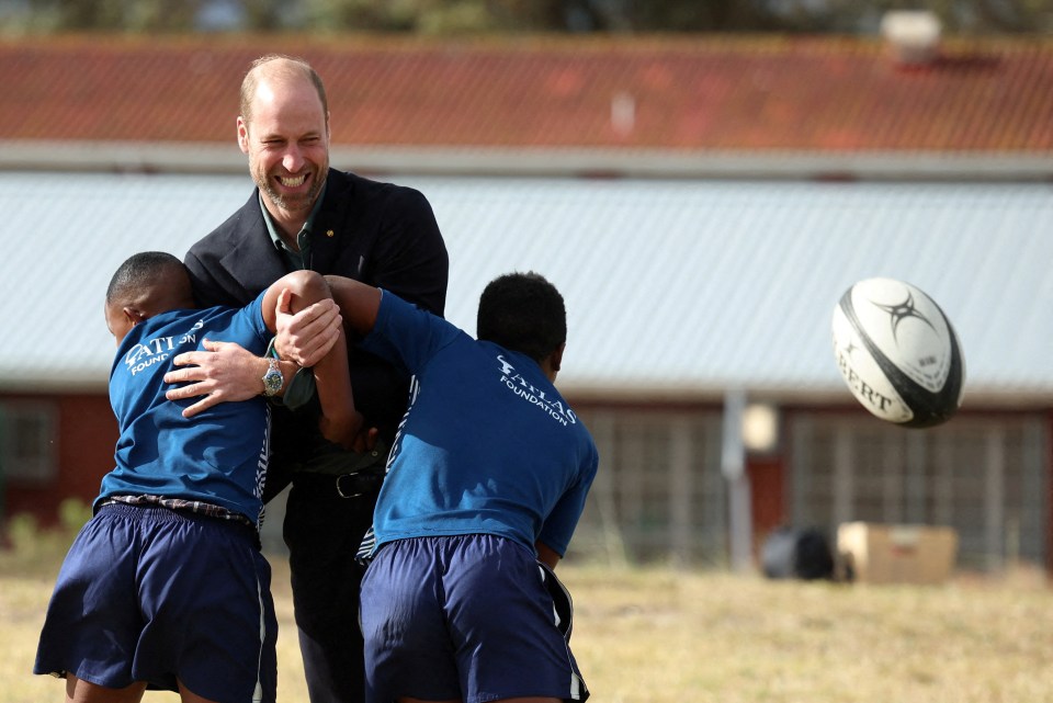 Prince William begins a South Africa trip by playing touch rugby with kids