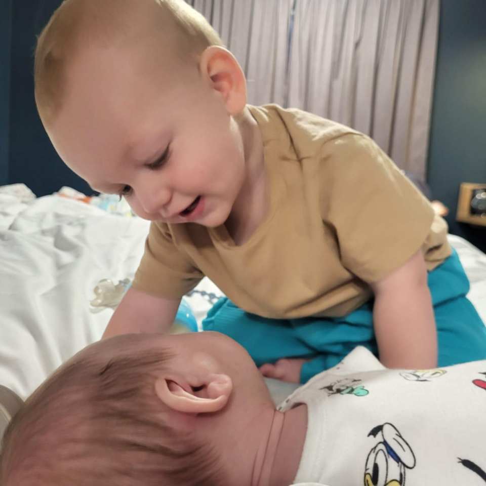 Firstborn Brodie (top) saying hello to his brother, Bailey, born only a year after he was