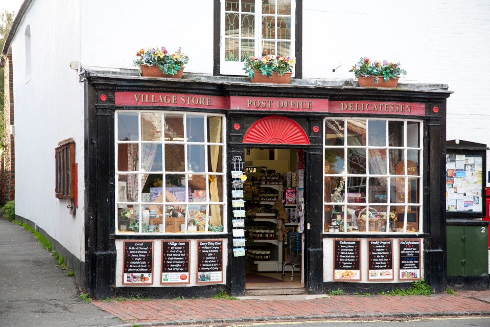 Pretty medieval houses line the high street in Alfriston, including the village store (pictured)