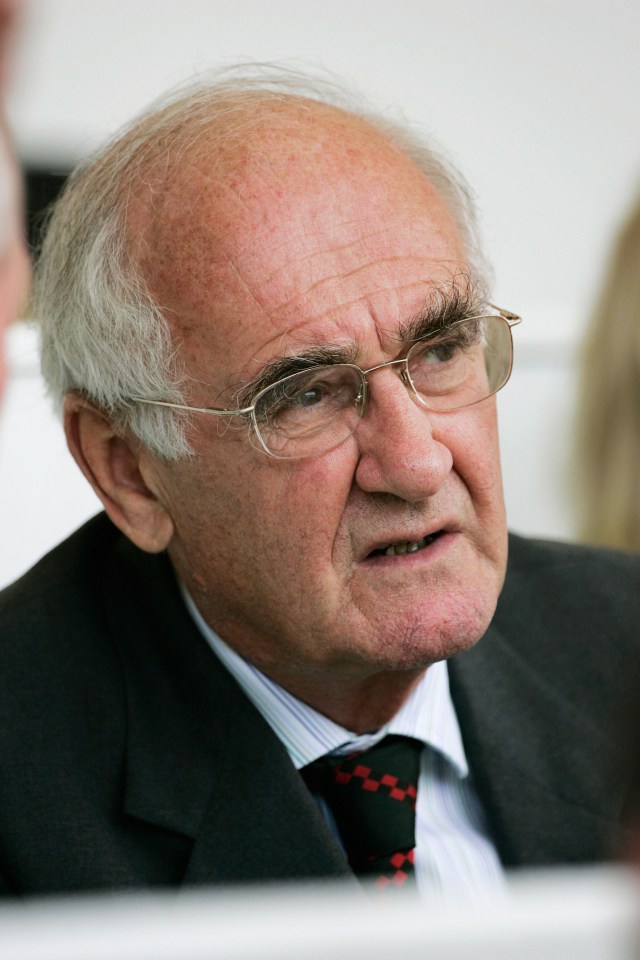 an older man wearing glasses and a suit and tie