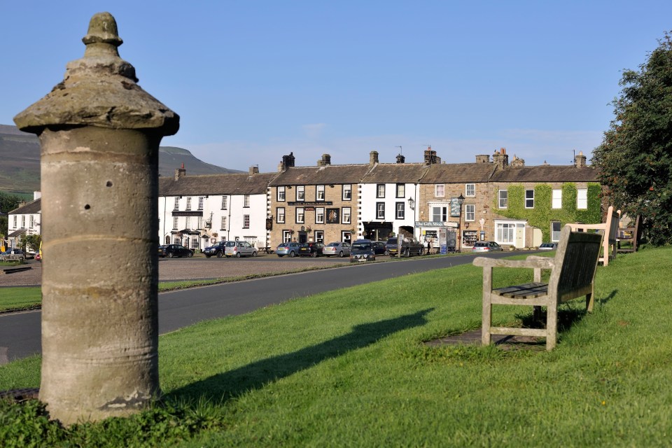 a row of buildings with a sign that says ' the crown inn ' on it