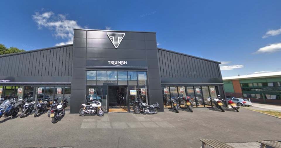 a triumph motorcycle dealership with motorcycles parked outside