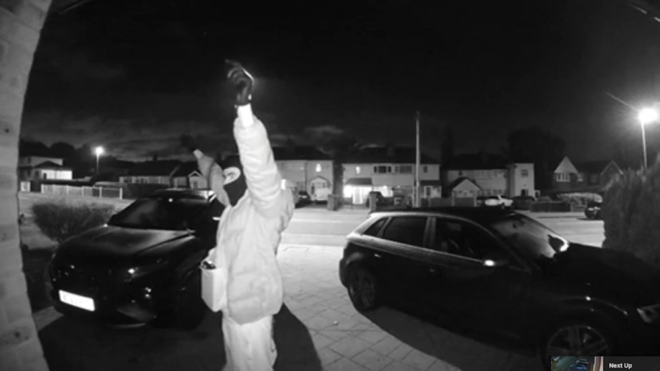 a black and white photo of a man wearing a mask and gloves