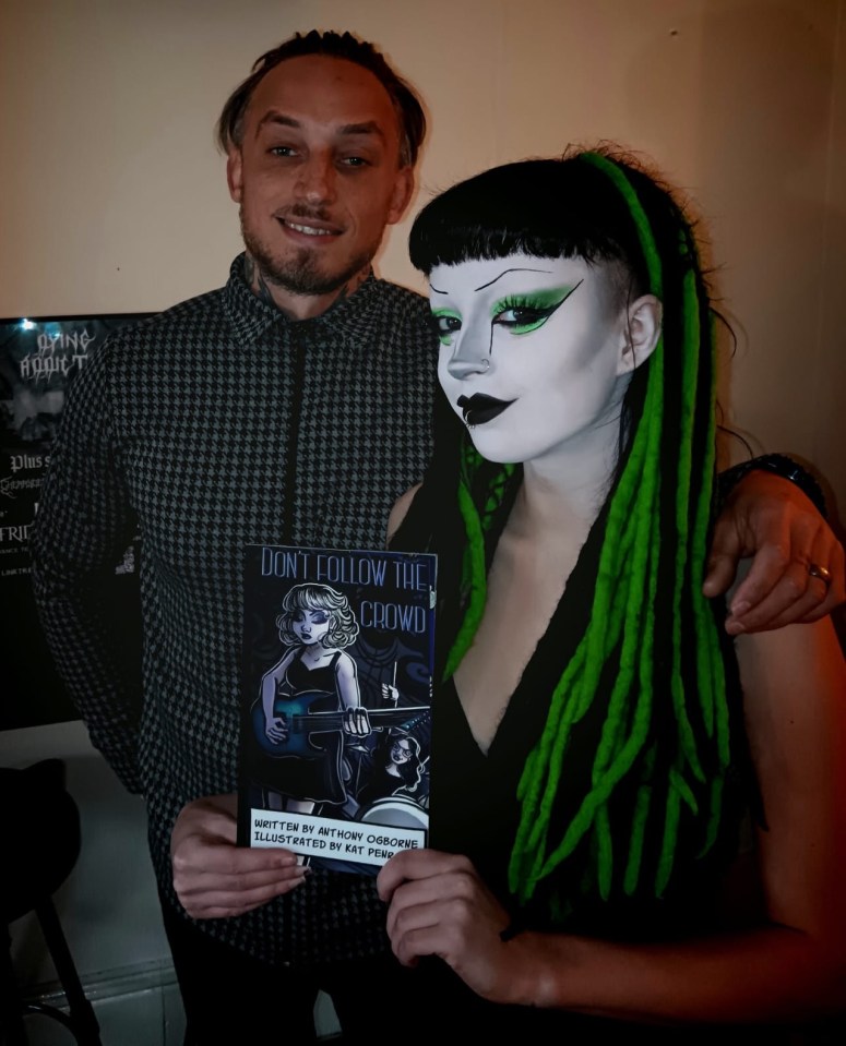 a man and a woman holding a book titled " don t follow the crowd "