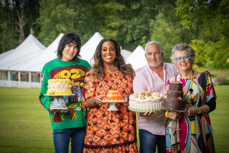 four people holding cakes with one wearing a green shirt that says oz