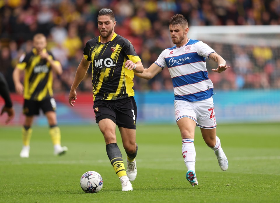 two soccer players on a field with one wearing a jersey that says georgia