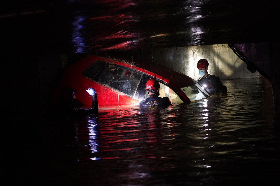 Civil Guards checking cars for bodies in a car park Paiporta