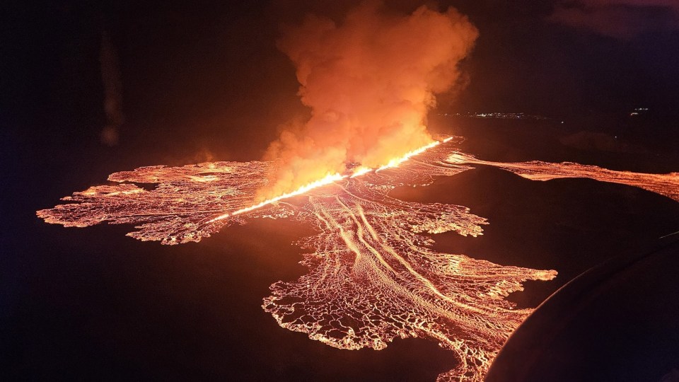 an aerial view of a volcanic eruption at night