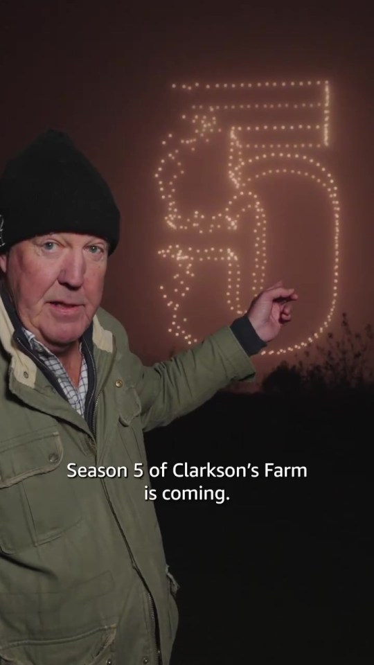 a man in a green jacket is pointing at a sign that says season 5 of clarkson 's farm is coming